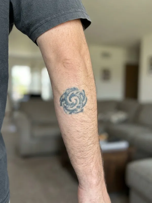 Old faded tribal tattoo on forearm before a cover-up